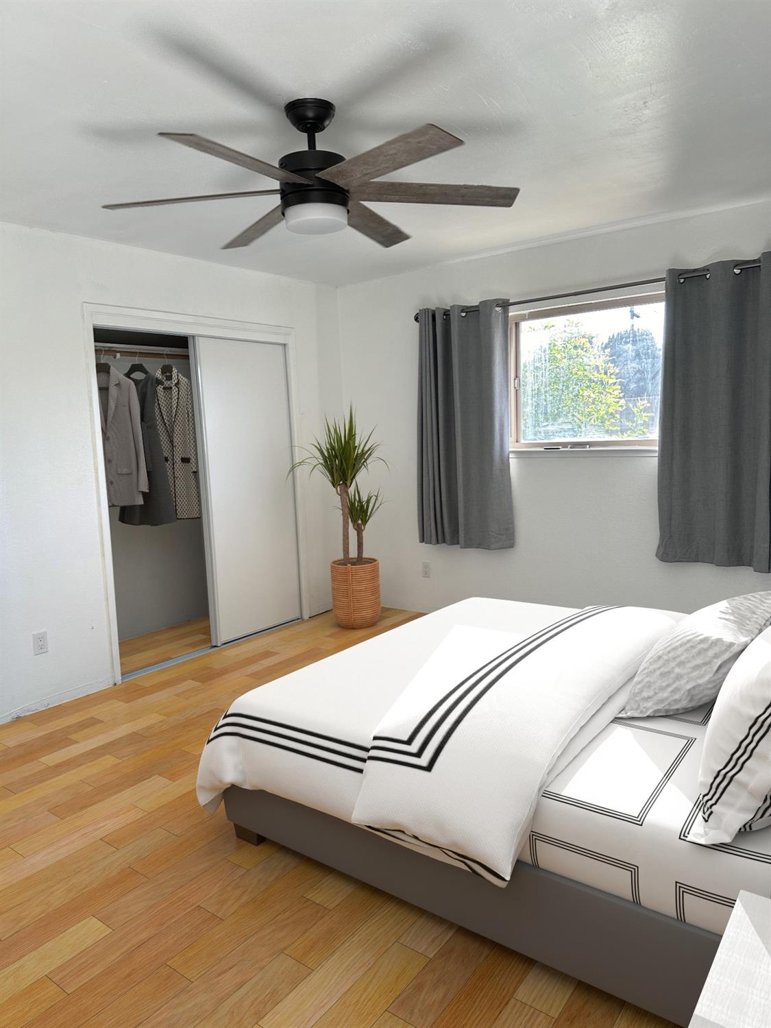 1319 Adler Drive Clovis, CA 93612 - Photo 6 of 20 a bedroom with a bed and a potted plant