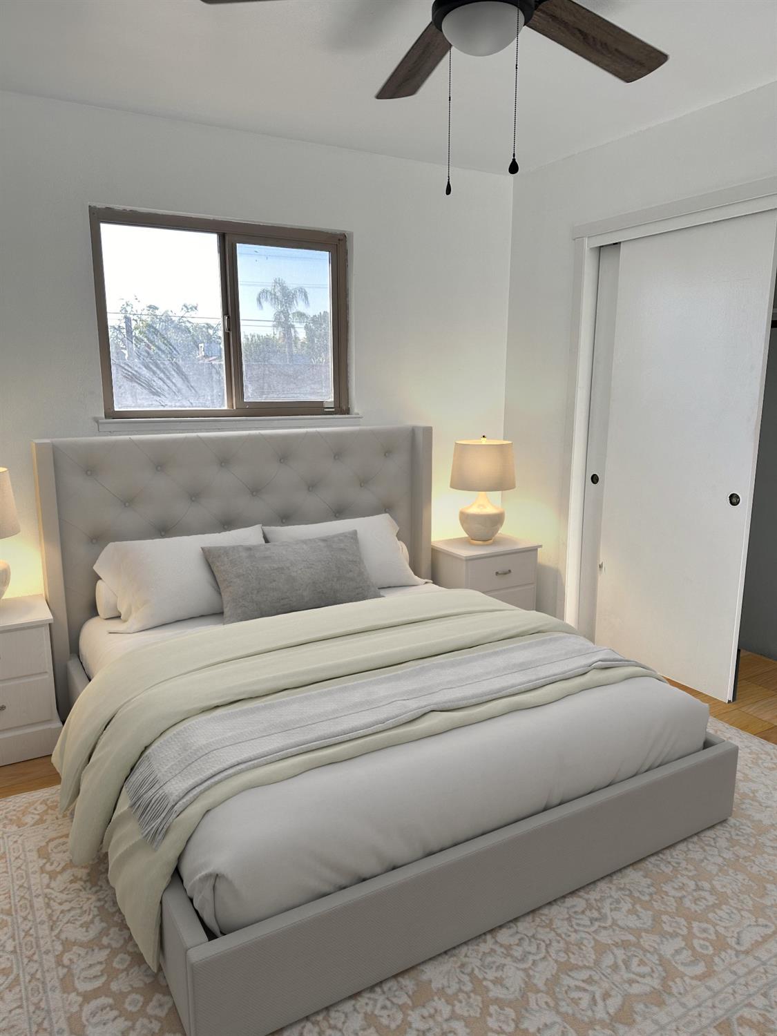 1319 Adler Drive Clovis, CA 93612 - Photo 9 of 20 a bedroom with a large bed and a window