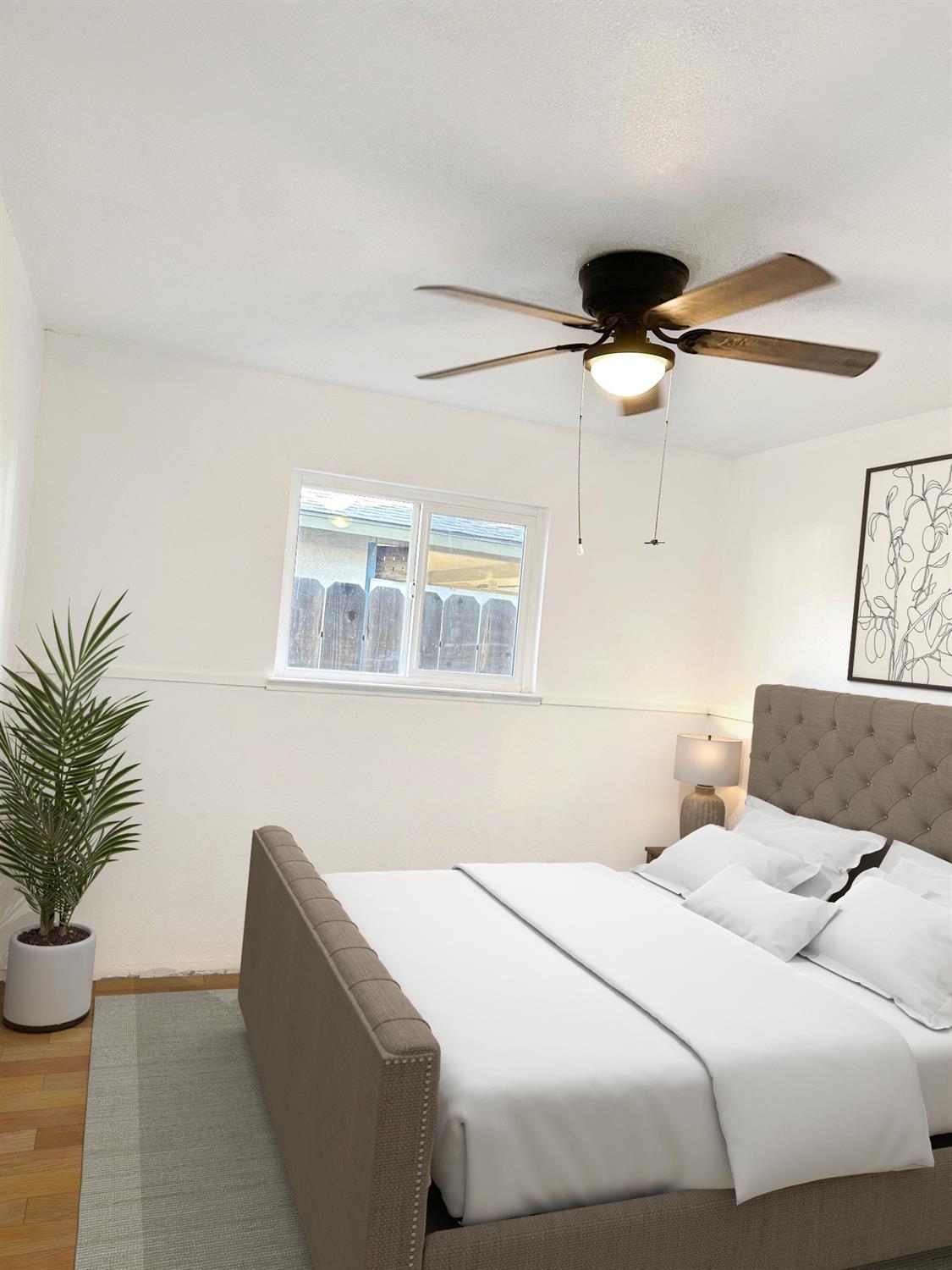 1319 Adler Drive Clovis, CA 93612 - Photo 10 of 20 a bedroom with a large bed and a potted plant
