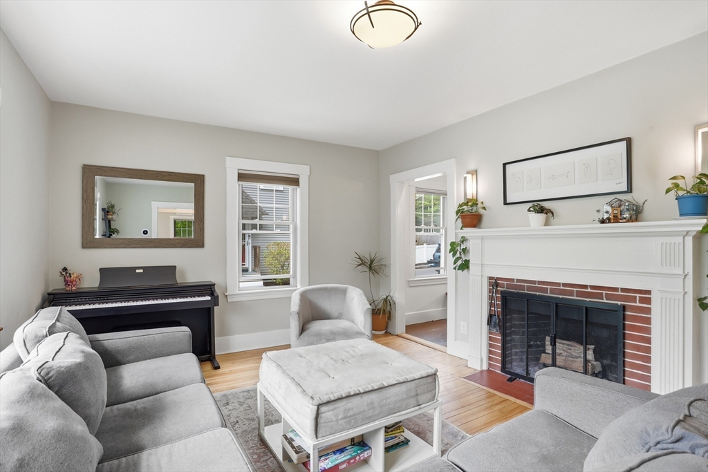 80 Concord Street Maynard, MA 01754 - Photo 2 of 29 a living room with furniture and a fireplace