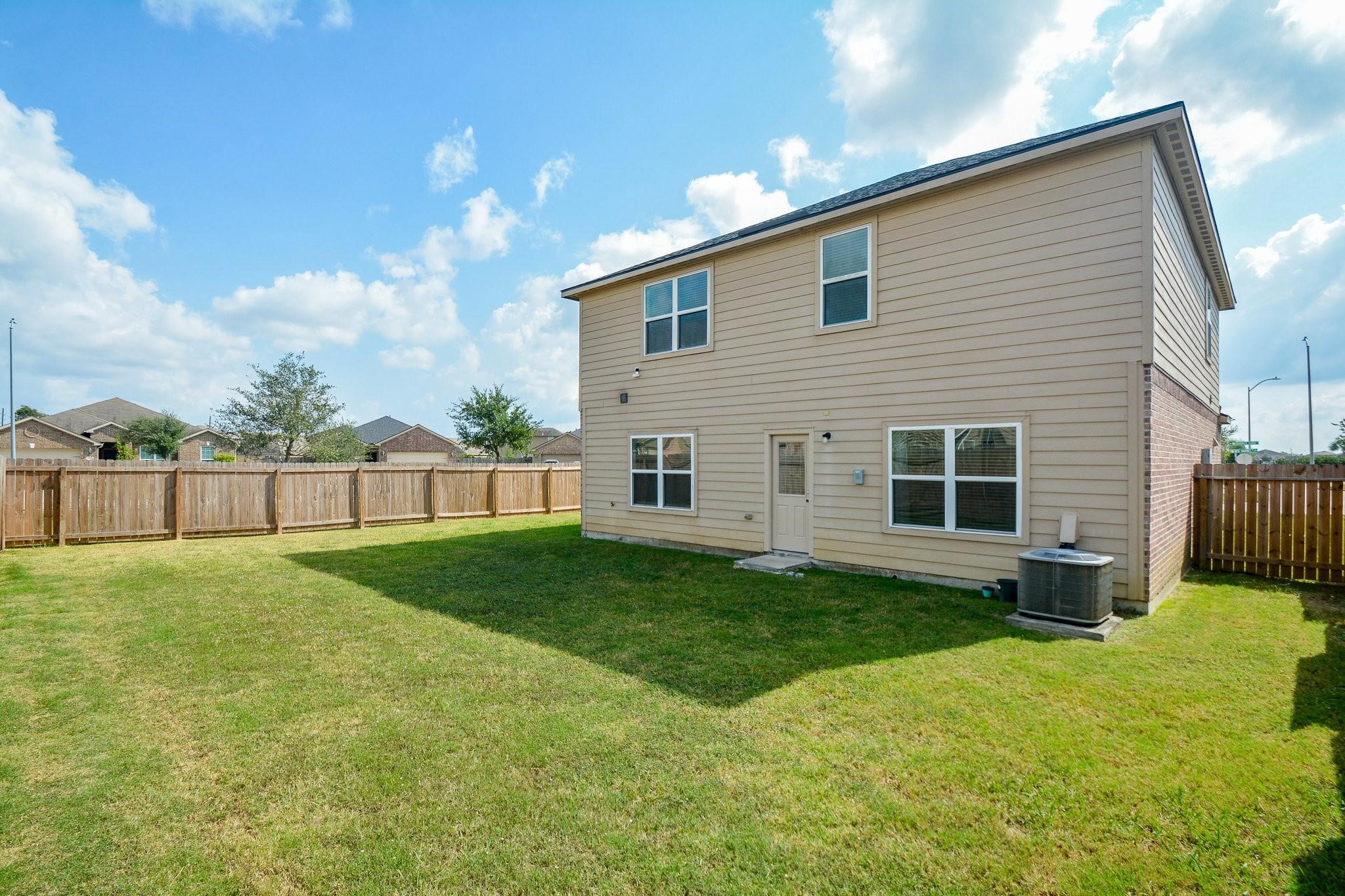 1322 Emerald Stone Drive Rosharon, TX 77583 - Photo 23 of 23 a view of a backyard with plants and a backyard