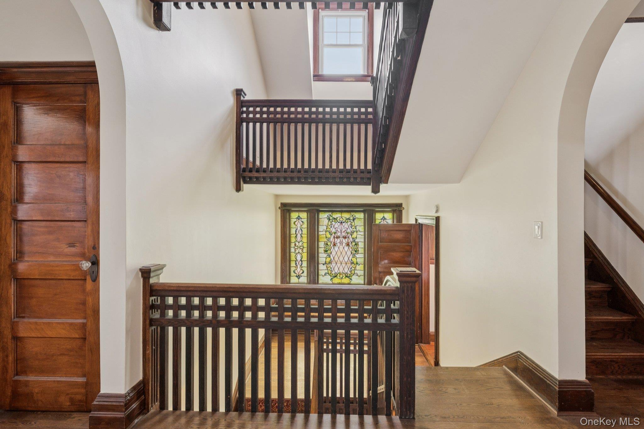397 Split Rock Road Syosset, NY 11791 - Photo 18 of 29 a view of a hallway with wooden floor and staircase