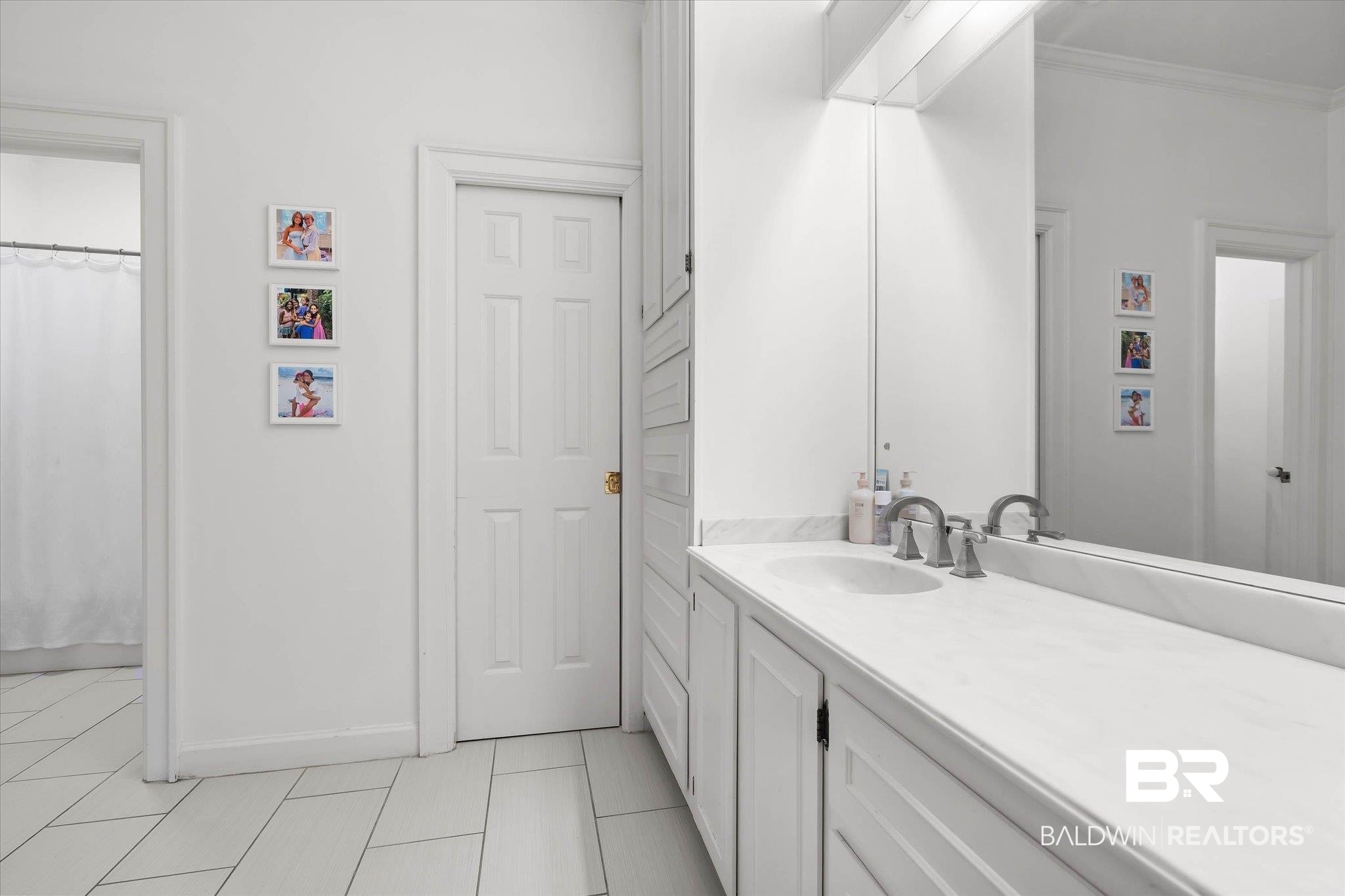 3908 Yester Place Mobile, AL 36608 - Photo 30 of 45 Bathroom vanity with an integrated sink, dual-handle faucet, and an expansive mirror