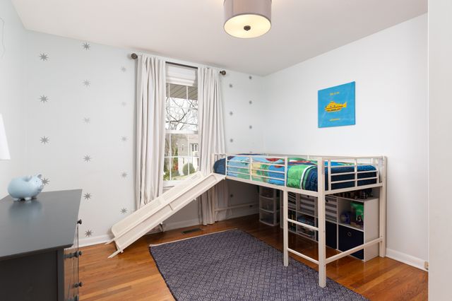 a room with wooden floor and windows