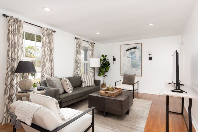a living room with furniture and wooden floor