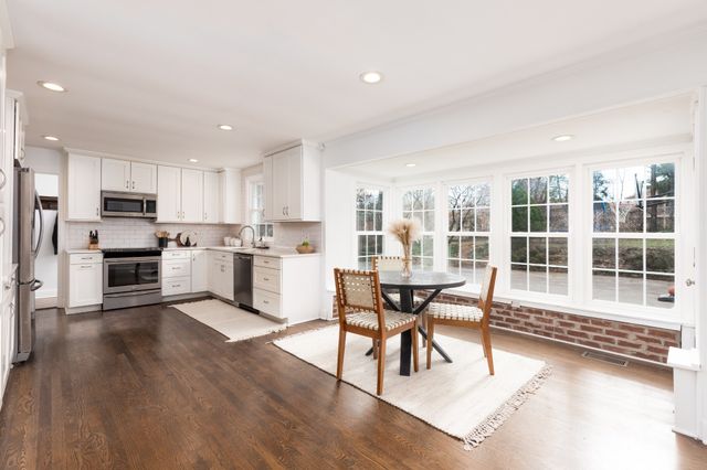 a dining room with furniture and kitchen view