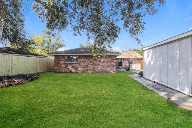 a view of a yard with a large tree