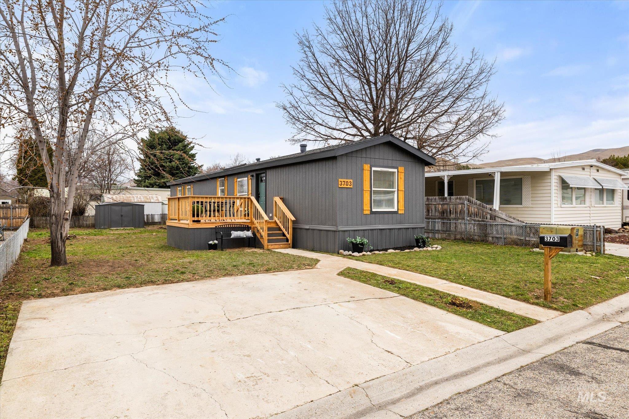 Manufactured / mobile home with a storage unit and a deck