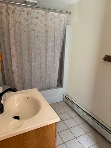 a bathroom with a bathtub and shower