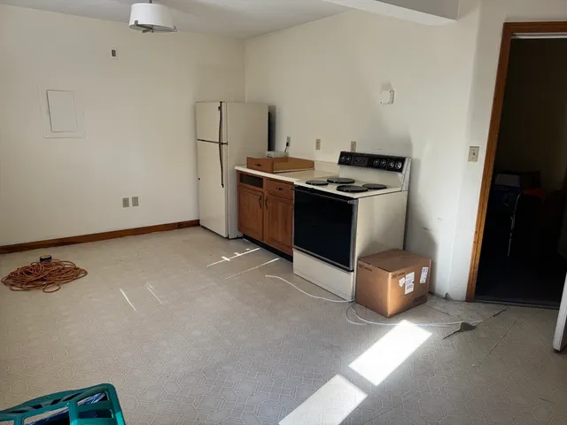 a kitchen with a stove and a refrigerator
