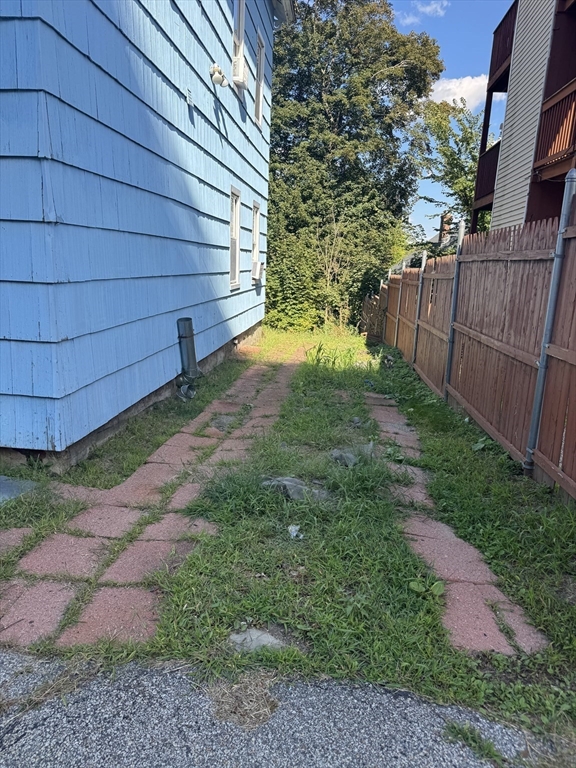 17 Thenius Street Worcester, MA 01607 - Photo 3 of 24 a view of a backyard with wooden fence
