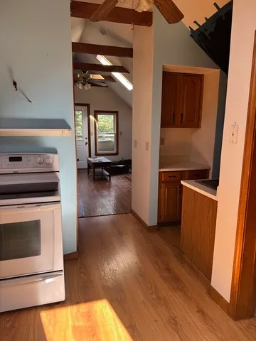 a kitchen with granite countertop a stove and a refrigerator