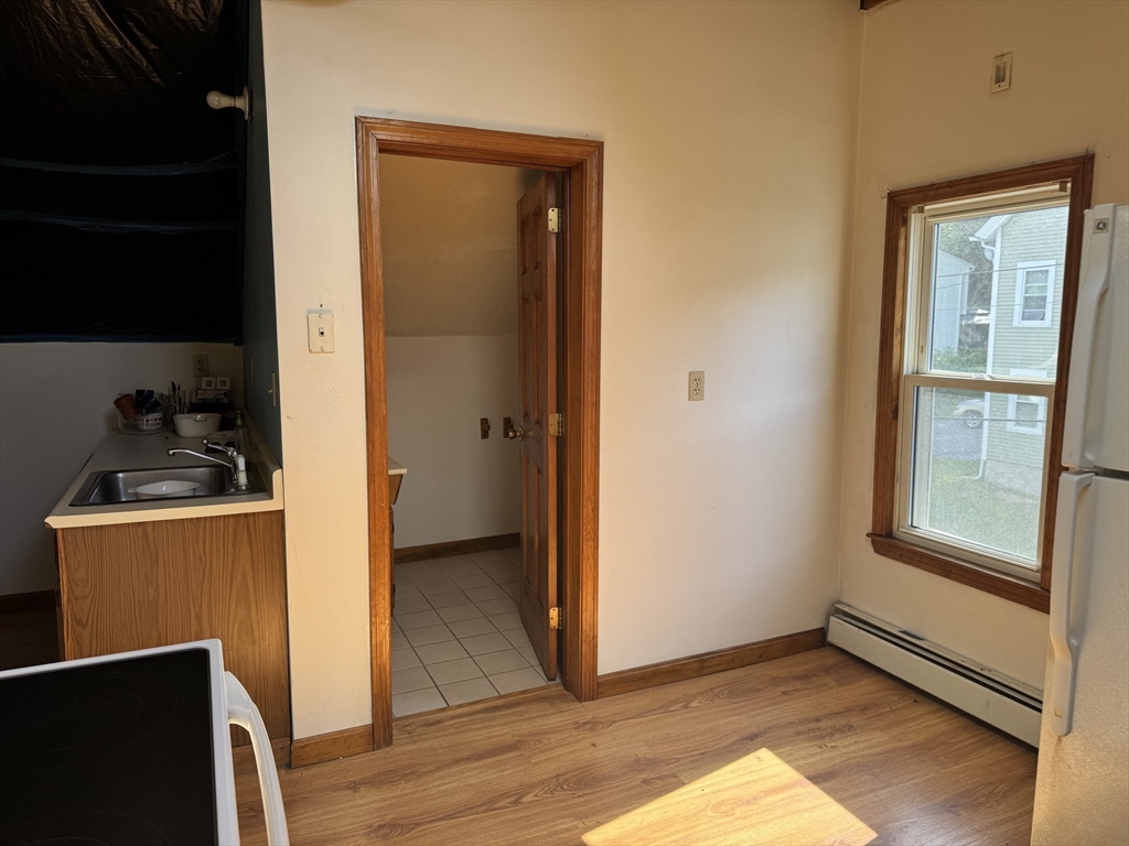 17 Thenius Street Worcester, MA 01607 - Photo 8 of 24 a view of an empty room with wooden floor and a window