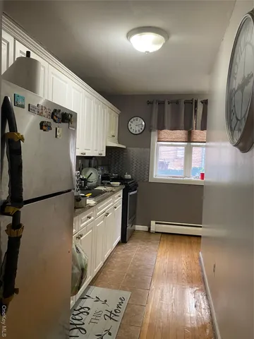 a kitchen with granite countertop a refrigerator a sink and a stove