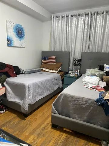 a bedroom with two beds and curtain