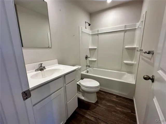 a bathroom with a sink toilet a mirror and shower