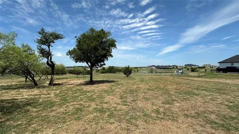 a view of a lake with a yard