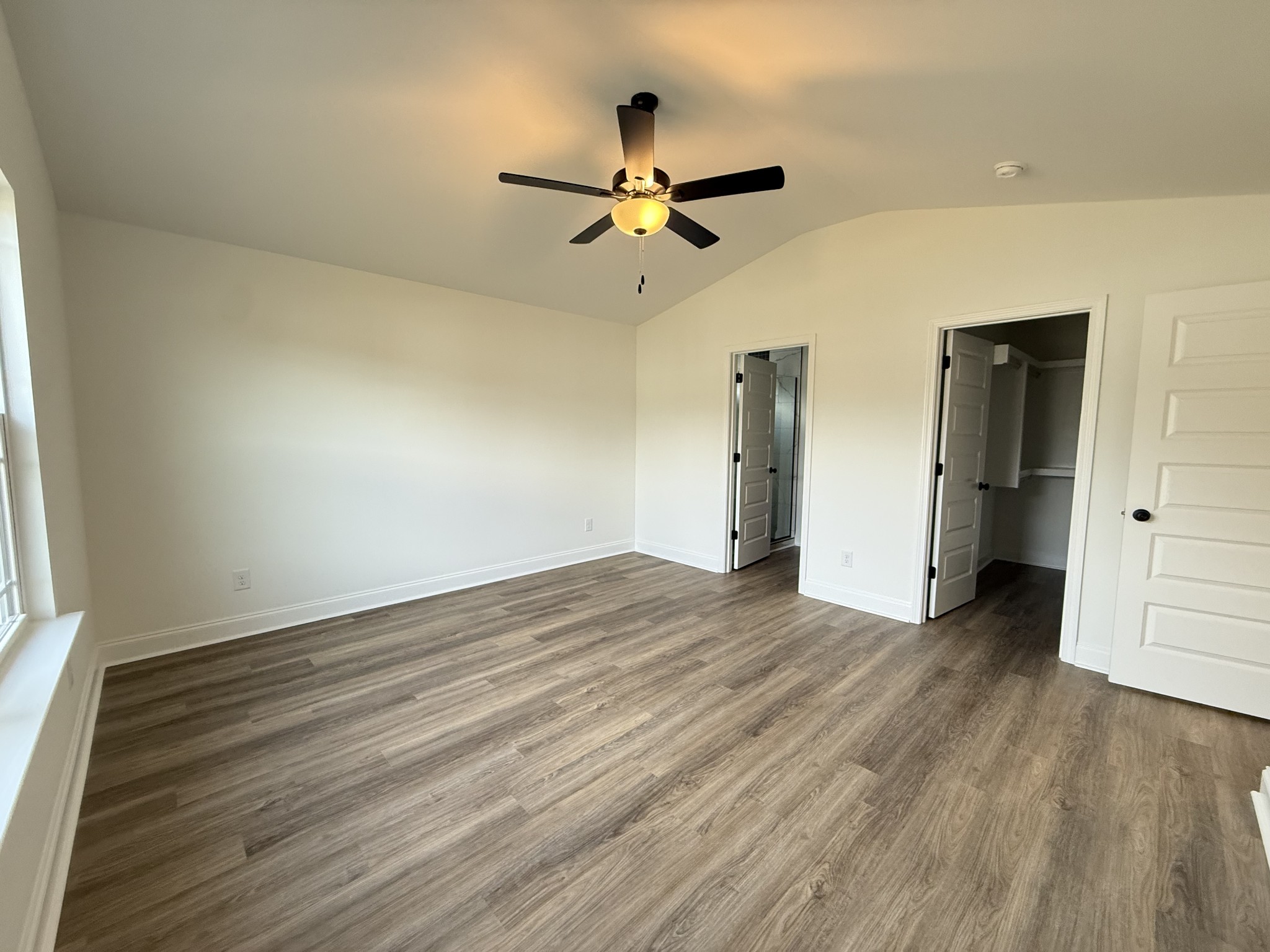 2092 Melanie Drive Springfield, TN 37172 - Photo 3 of 5 an empty room with wooden floor a ceiling fan and kitchen view