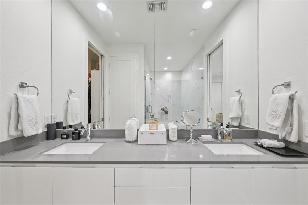 4511 Arberry Lane Dallas, TX 75219 - Photo 15 of 40 Primary bath with dual vanities and modern finishes.