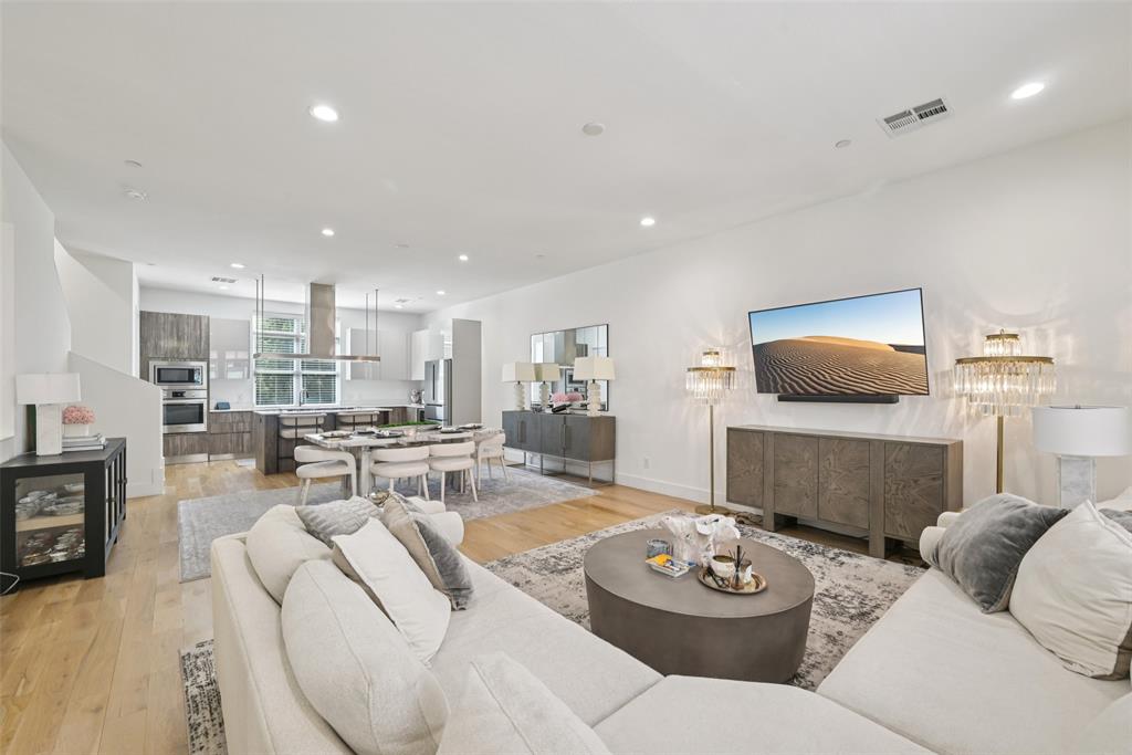 4511 Arberry Lane Dallas, TX 75219 - Photo 3 of 40 Open-concept flow connects living, dining, and kitchen — made for entertaining.