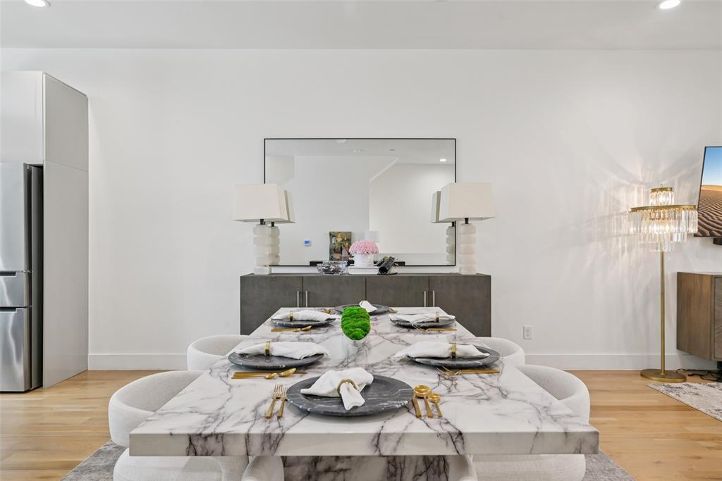 4511 Arberry Lane Dallas, TX 75219 - Photo 5 of 40 Sleek dining space with wood floors and recessed lighting to set the mood.