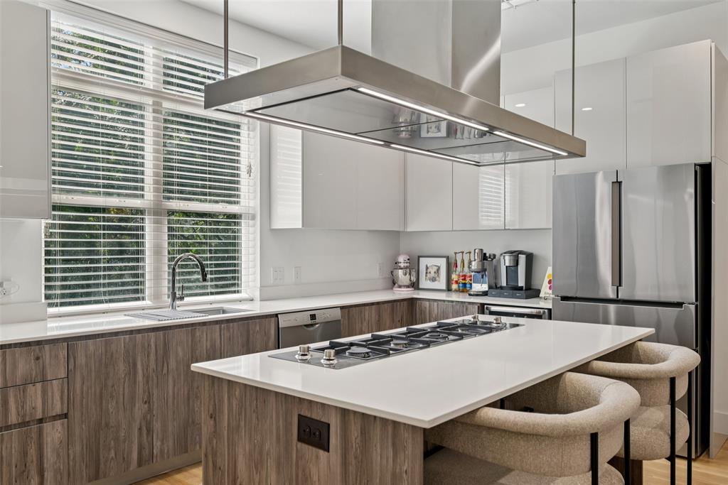 4511 Arberry Lane Dallas, TX 75219 - Photo 8 of 40 Clean-lined cabinetry, stainless appliances, and windows that keep it bright.