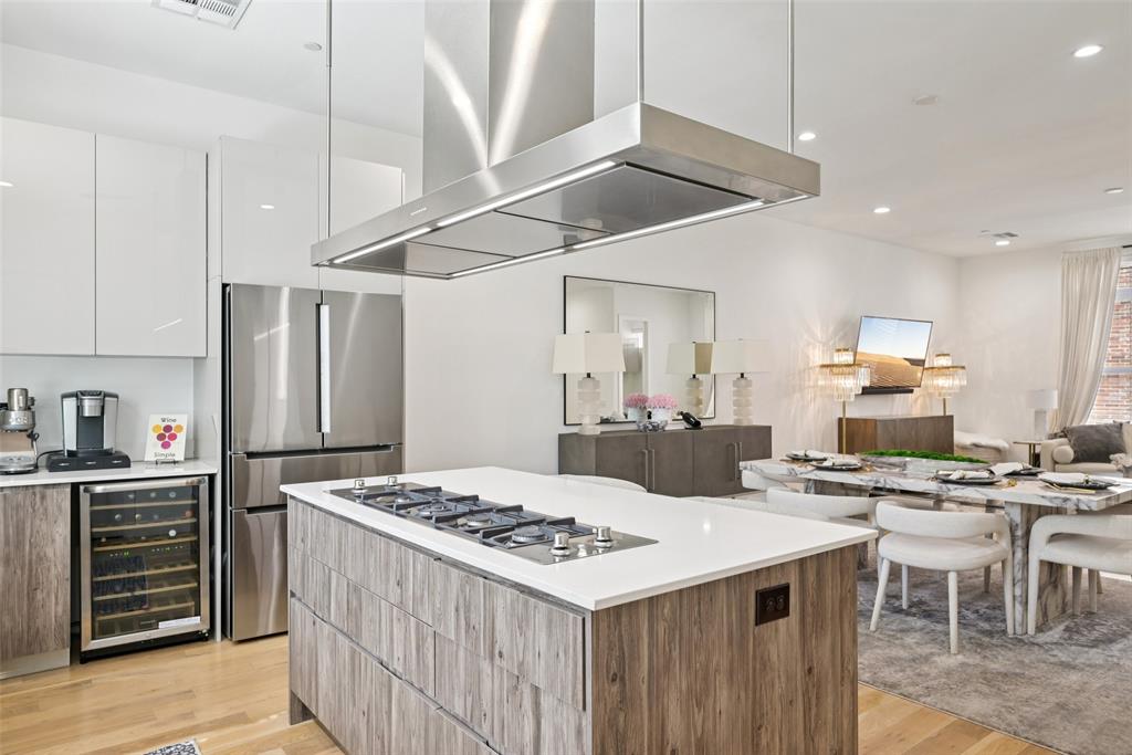 4511 Arberry Lane Dallas, TX 75219 - Photo 9 of 40 Kitchen island doubles as a prep station and casual hangout spot.