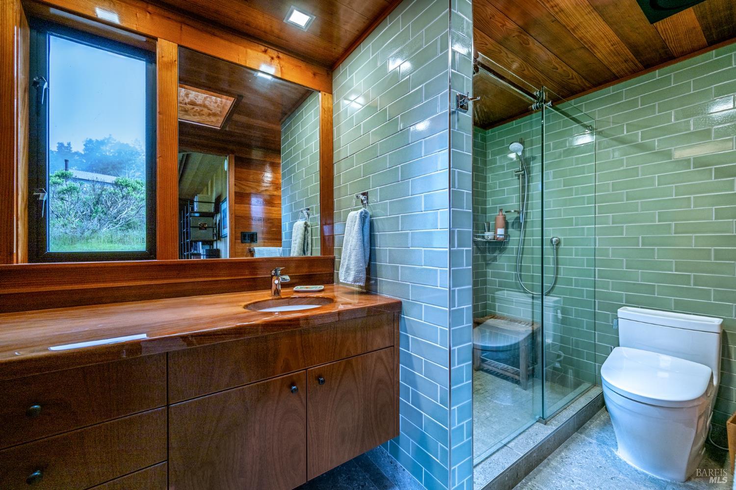 326 Conifer Close The Sea Ranch, CA 95497 - Photo 17 of 26 Newly remodeled bathroom with mahogany varnished vanity, tiled showed, smart toilet and radiant heated tile flooring.