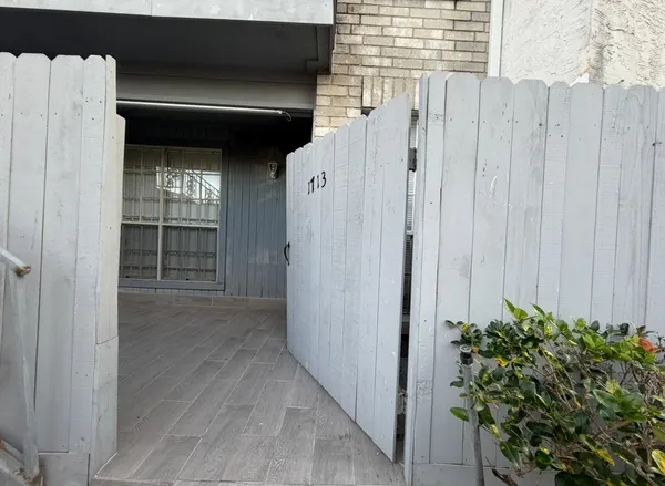 a view of a front door and wooden door
