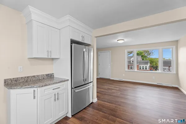 a kitchen with a refrigerator and window