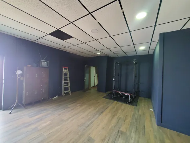 a room with a bed and a dresser