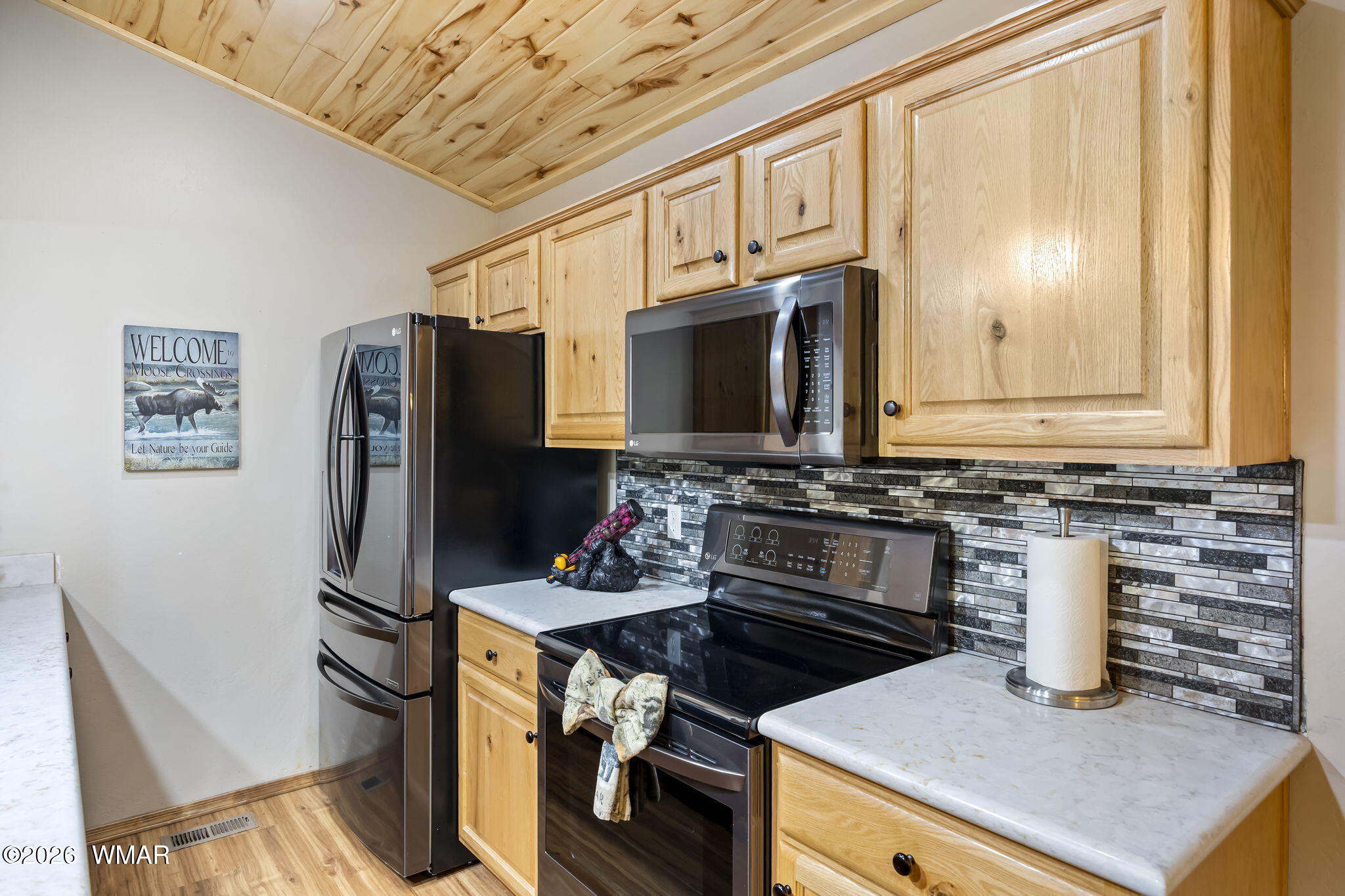 2337 Buffalo Loop Overgaard, AZ 85933 - Photo 12 of 43 a kitchen with stainless steel appliances granite countertop a refrigerator stove and microwave