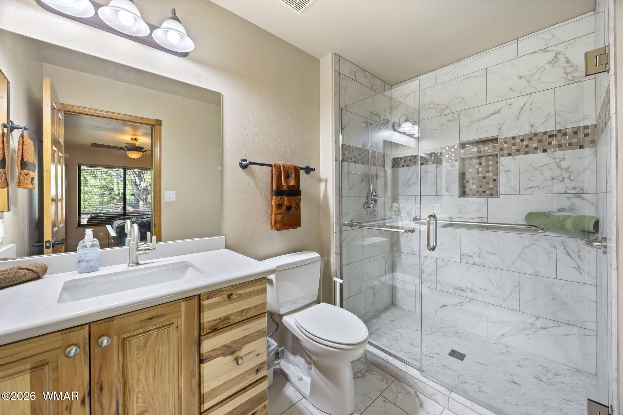 2337 Buffalo Loop Overgaard, AZ 85933 - Photo 16 of 43 a bathroom with a granite countertop sink toilet a mirror and shower
