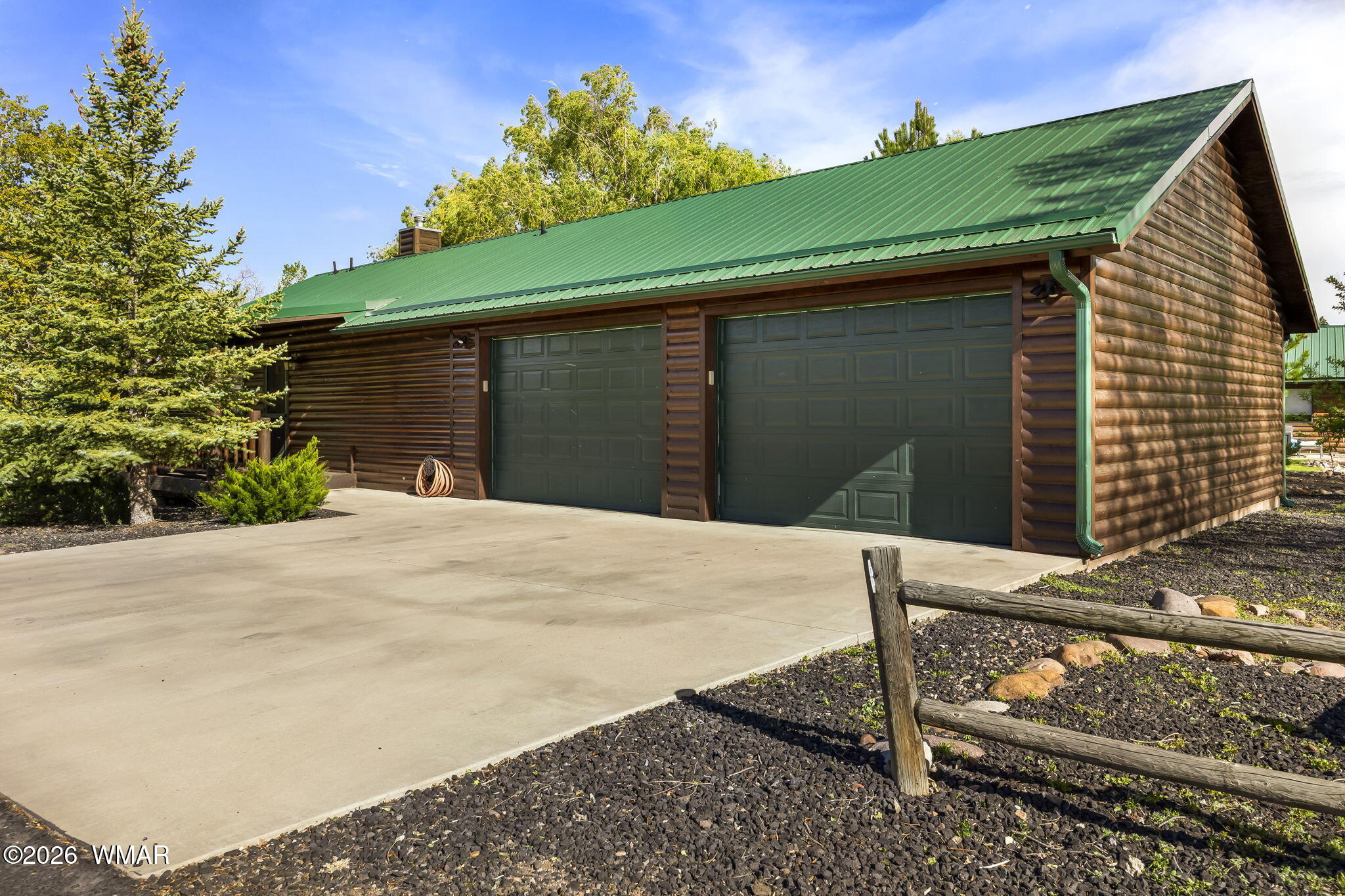 2337 Buffalo Loop Overgaard, AZ 85933 - Photo 2 of 43 a front view of a house with a yard and garage