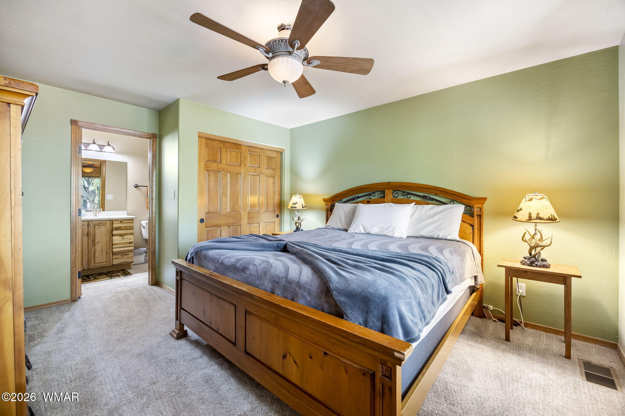 2337 Buffalo Loop Overgaard, AZ 85933 - Photo 6 of 43 a bedroom with a bed and a chandelier
