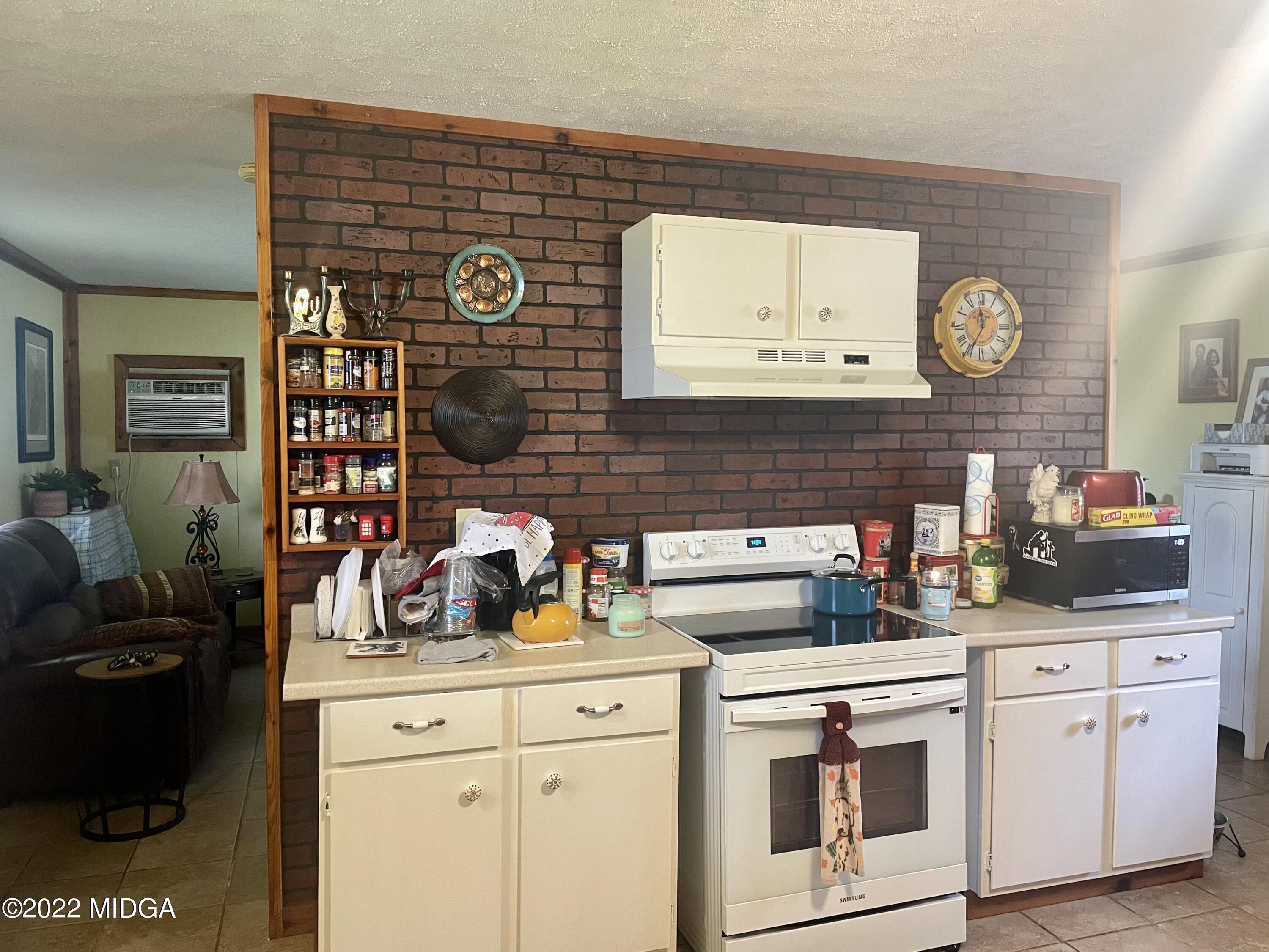 62 McMullen Road Forsyth, GA 31029 - Photo 3 of 10 a kitchen with a cabinets and a stove