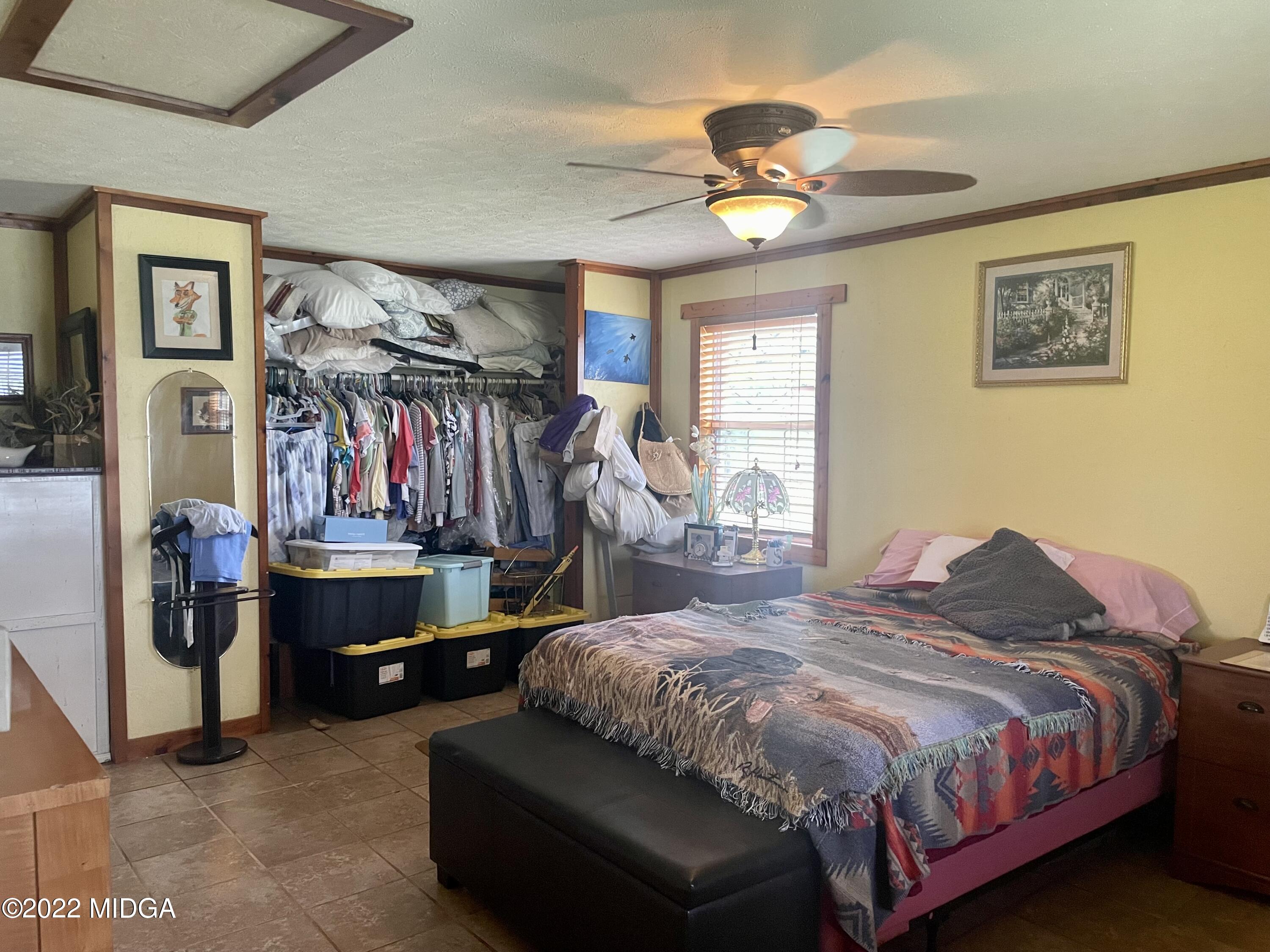62 McMullen Road Forsyth, GA 31029 - Photo 6 of 10 a bedroom with a bed and a chandelier