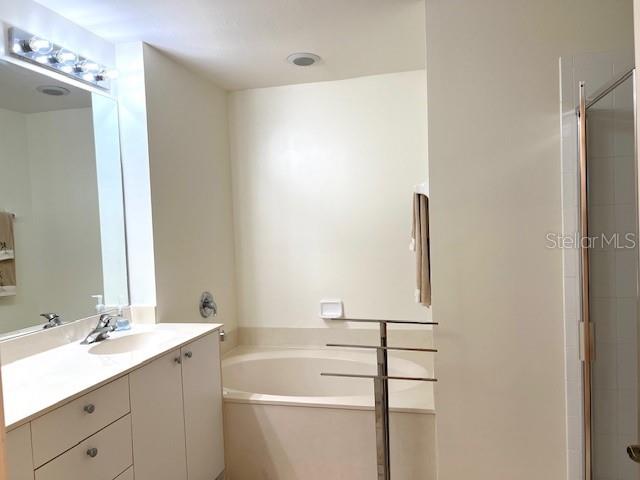 2060 Matecumbe Key Road, Unit 2301 Punta Gorda, FL 33955 - Photo 13 of 41 a bathroom with a bathtub sink vanity and mirror