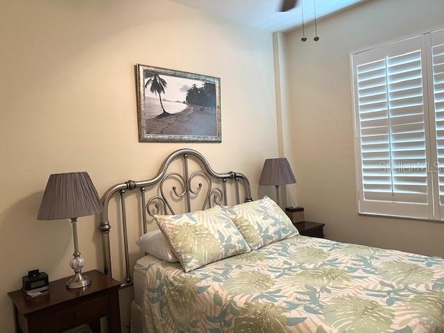 2060 Matecumbe Key Road, Unit 2301 Punta Gorda, FL 33955 - Photo 17 of 41 a bedroom with a bed and a lamp on dresser