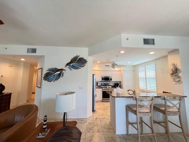 2060 Matecumbe Key Road, Unit 2301 Punta Gorda, FL 33955 - Photo 7 of 41 a living room with furniture and a wooden floor