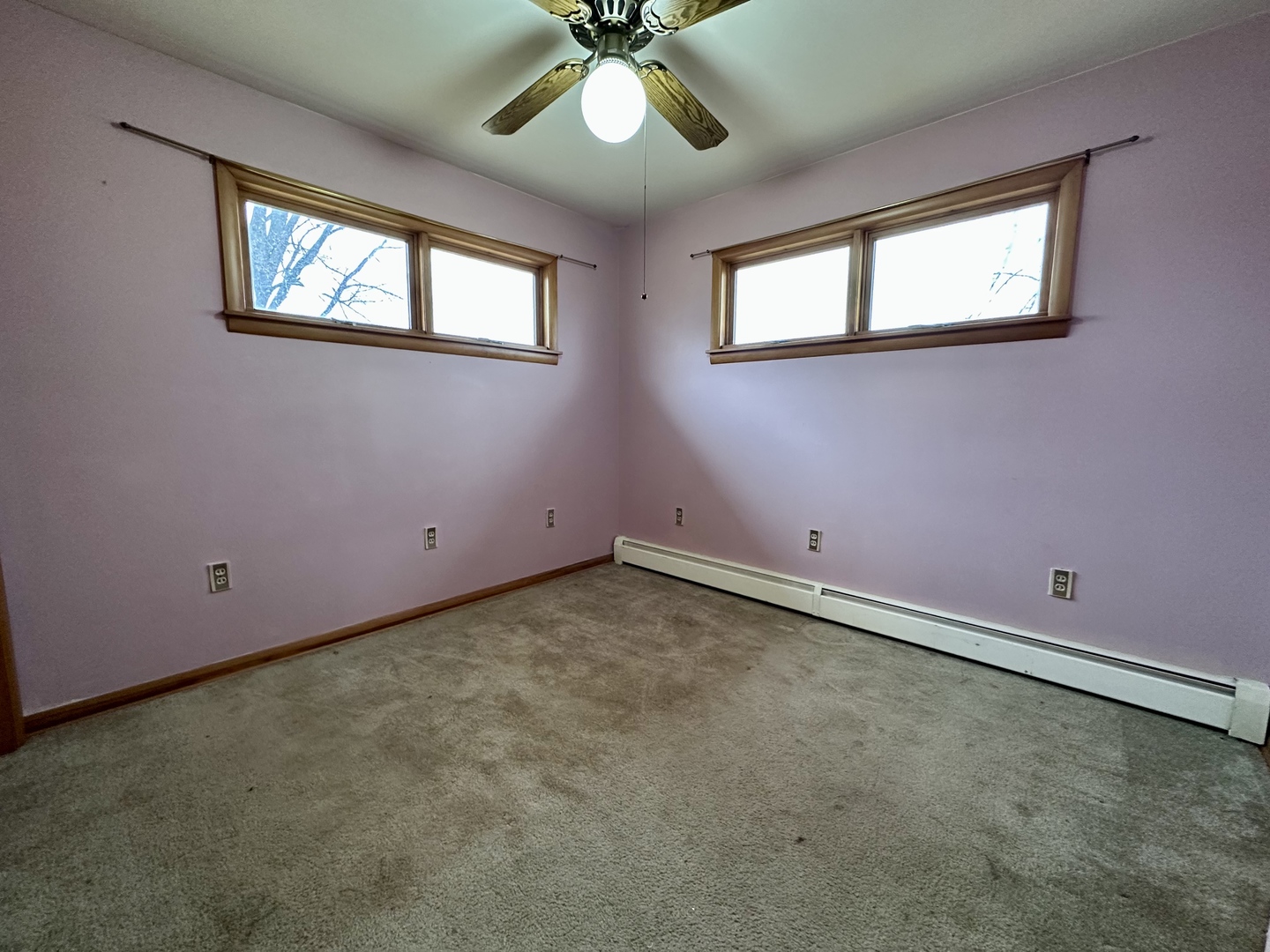 3912 Emerson Road Sterling, IL 61081 - Photo 12 of 22 an empty room with windows and fan