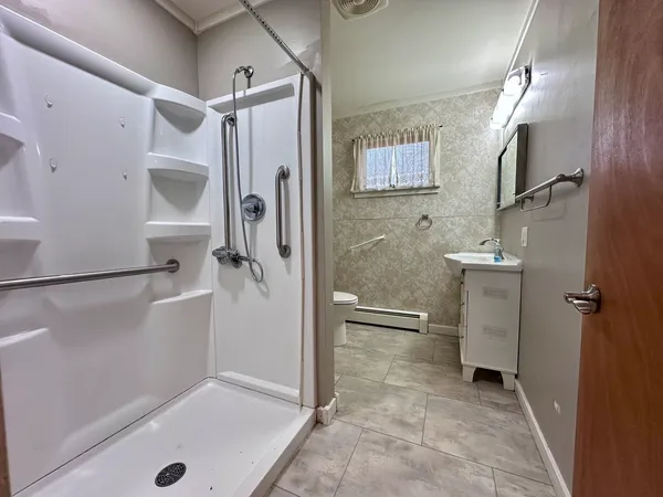 a bathroom with a shower and a sink