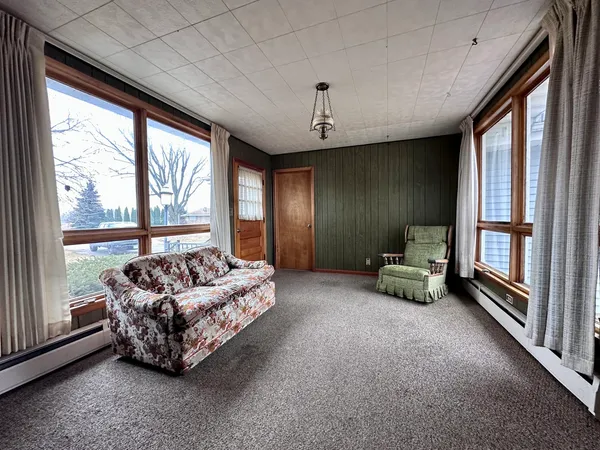 a spacious bedroom with furniture and a large window