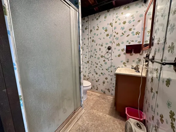 a bathroom with a toilet and a shower curtain