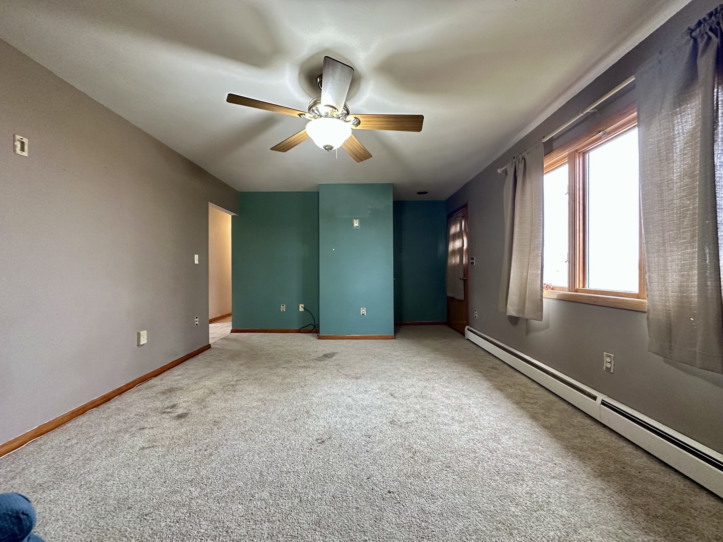 3912 Emerson Road Sterling, IL 61081 - Photo 3 of 22 an empty room with windows and fan