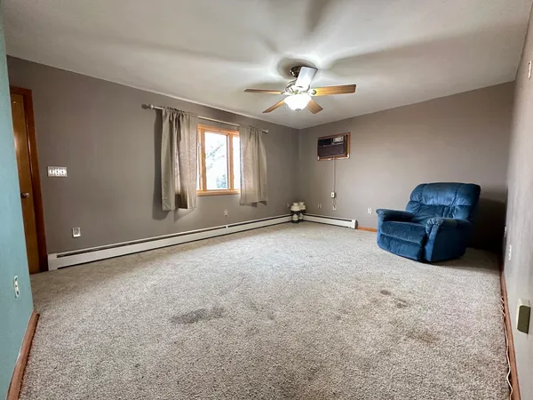 a view of a livingroom with a ceiling fan and window