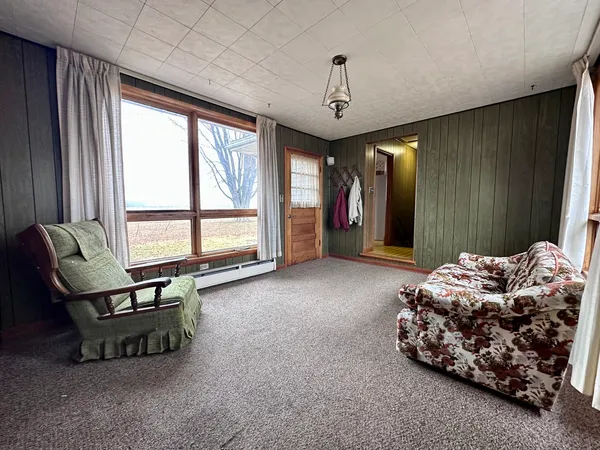 a spacious bedroom with a bed and a chandelier