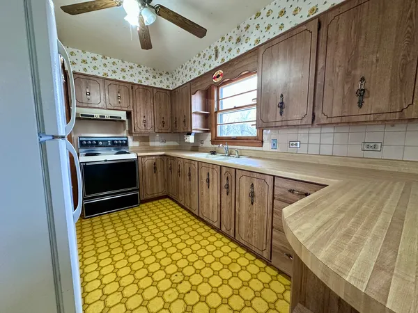 a kitchen with stainless steel appliances granite countertop a sink and cabinets