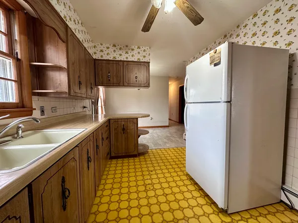 a kitchen with a refrigerator a sink and dishwasher