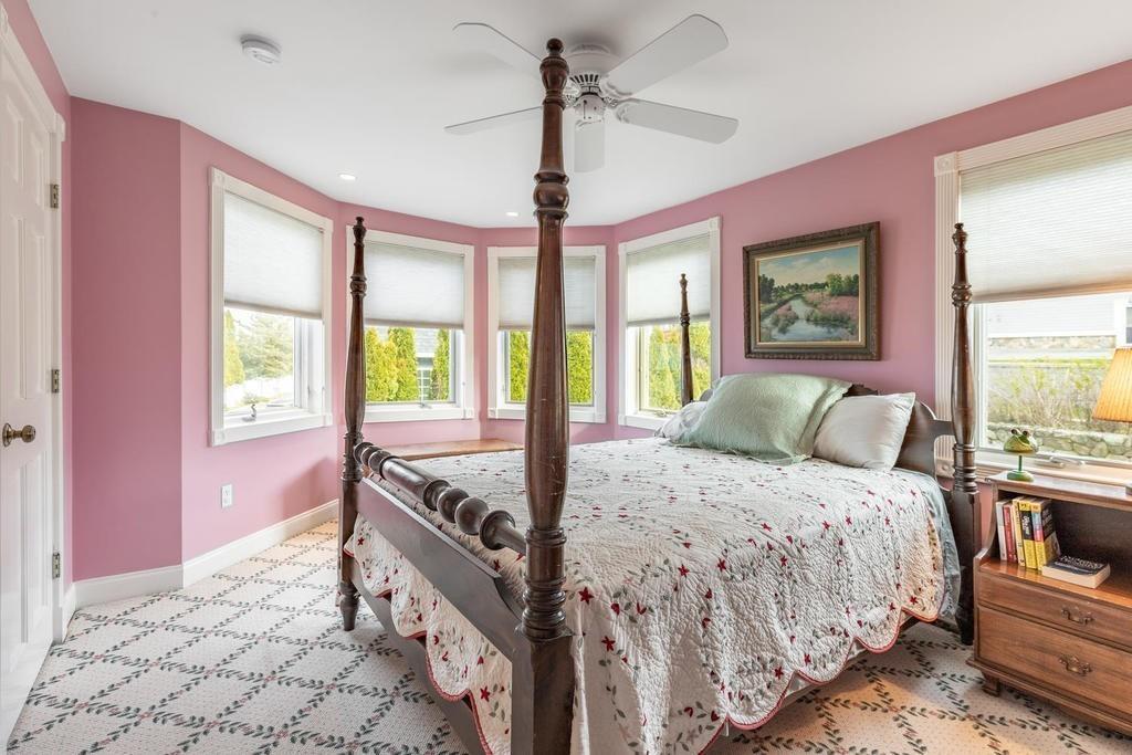 79 Clark Road Ipswich, MA 01938 - Photo 23 of 35 a bedroom with a bed and a chandelier